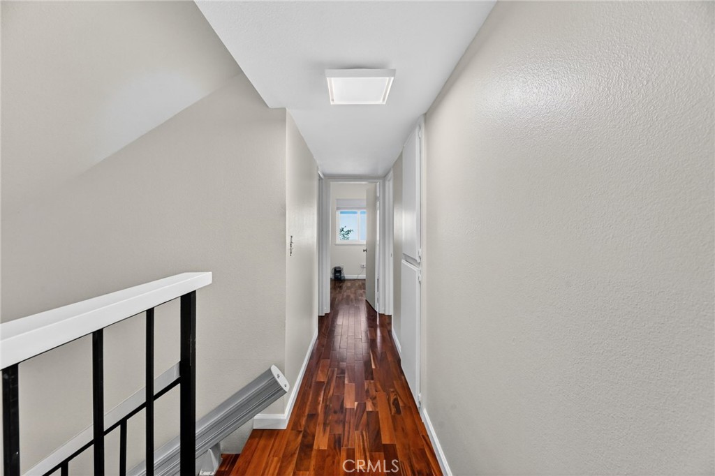 6116 East Paseo Rio Azul Anaheim, CA 92807 - Photo 28 of 54 a view of a hallway with wooden floor and staircase