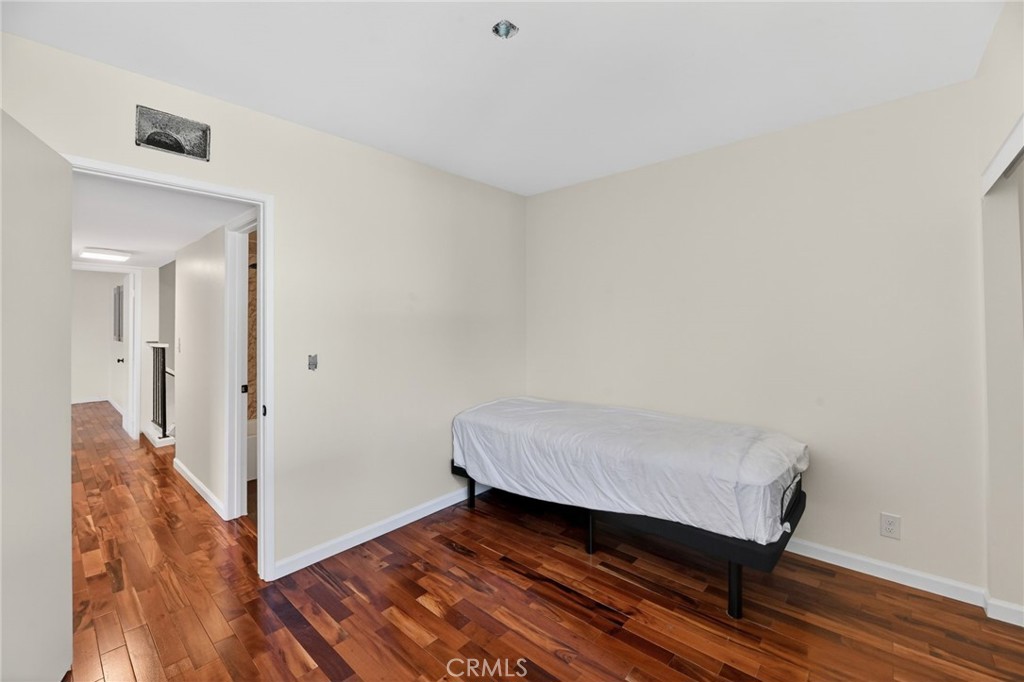 6116 East Paseo Rio Azul Anaheim, CA 92807 - Photo 38 of 54 a hallway with sliding door and wooden floor