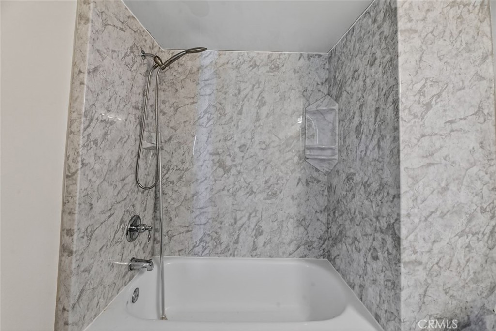 6116 East Paseo Rio Azul Anaheim, CA 92807 - Photo 39 of 54 a bath tub sitting next to a white sink and vanity