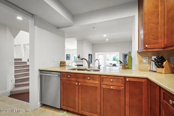 a kitchen with sink and cabinets