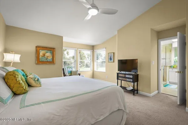 a bedroom with a bed and a television