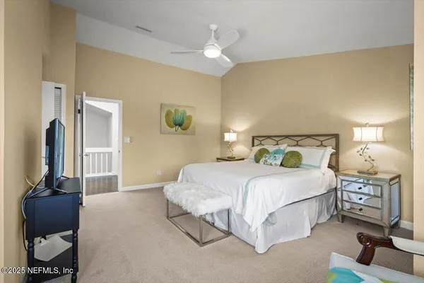 a bedroom with a bed and a mirror