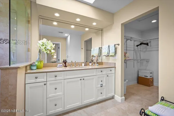 a spacious bathroom with double sink and a mirror