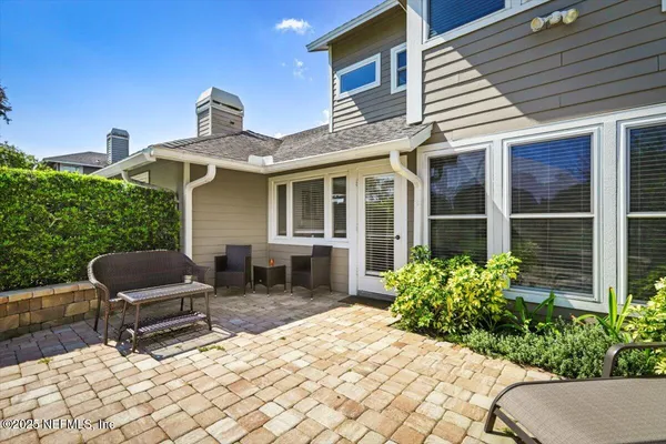 a front view of a house with outdoor seating and a potted plant