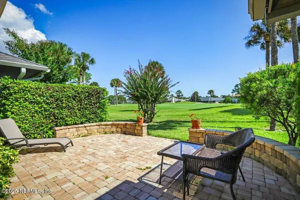a view of a backyard with a garden and seating area