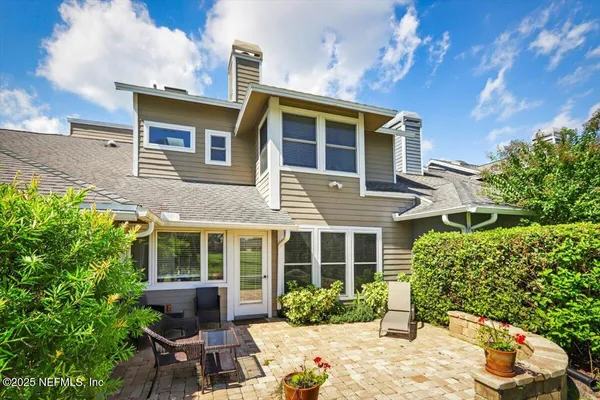 a view of a house with a yard and sitting area