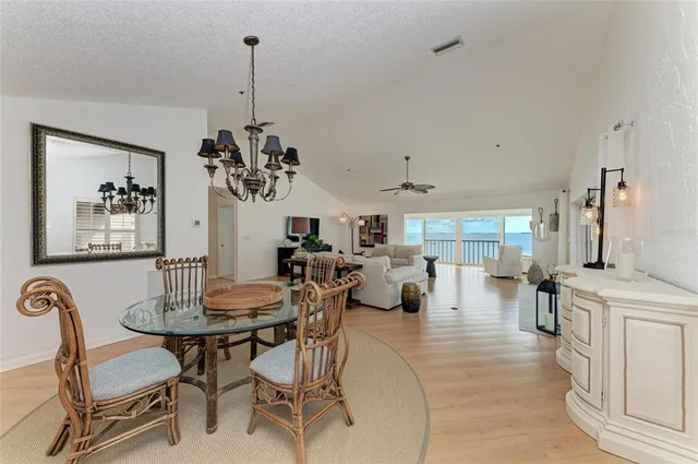 a kitchen with granite countertop a sink cabinets stainless steel appliances and a window