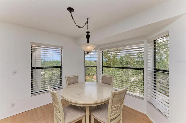 a spacious bedroom with a bed a couch and a large window