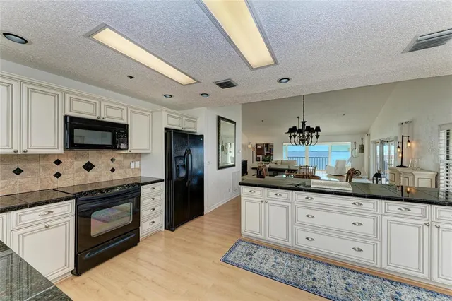 a bed sitting in a spacious bedroom next to a window