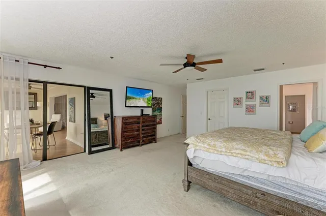 a spacious bedroom with a large bed and a large window