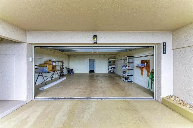 an aerial view of a house with a swimming pool and sitting space