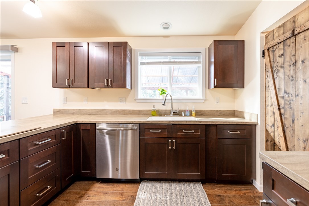 5425 188th Avenue Southwest Rochester, WA 98579 - Photo 14 of 40 a sink with wooden cabinets and a sink