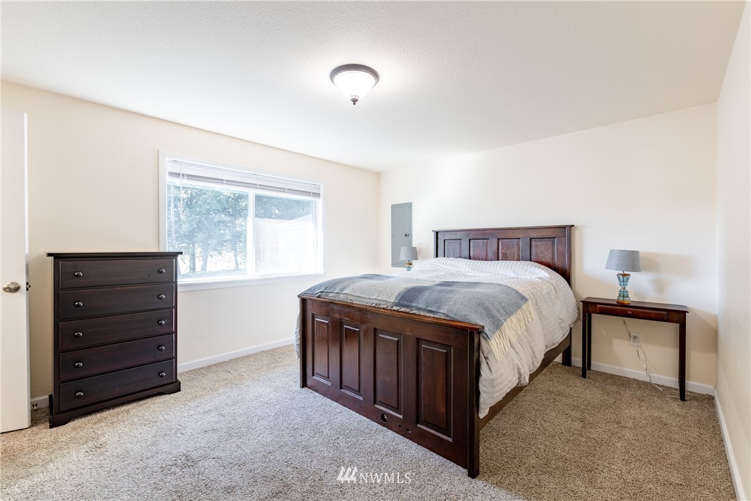 5425 188th Avenue Southwest Rochester, WA 98579 - Photo 24 of 40 a spacious bedroom with a bed and a window