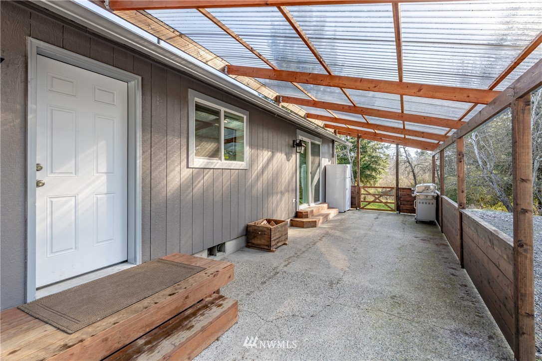 5425 188th Avenue Southwest Rochester, WA 98579 - Photo 31 of 40 a view of a backyard with furniture and floor to ceiling window