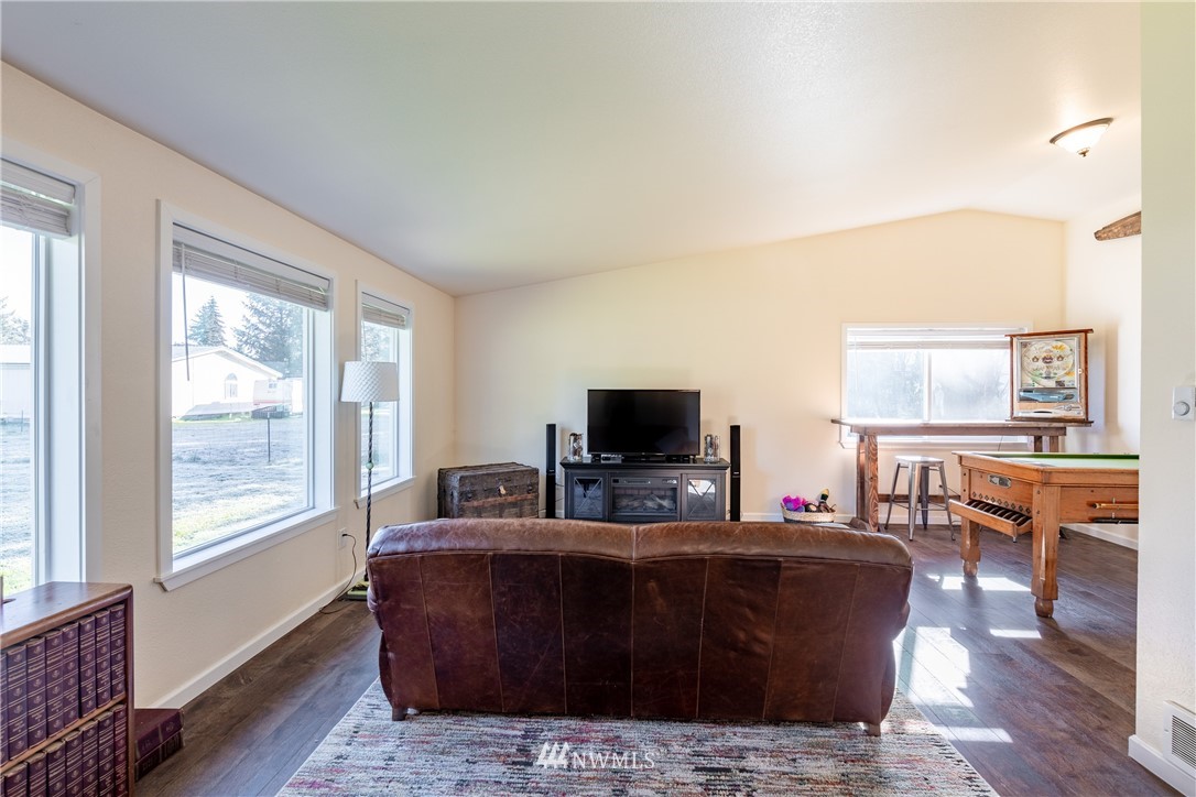 5425 188th Avenue Southwest Rochester, WA 98579 - Photo 7 of 40 a living room with furniture and a flat screen tv