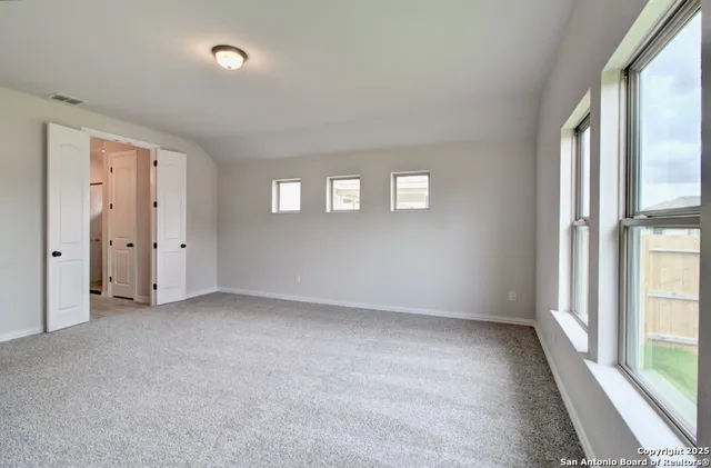 a view of an empty room with a window