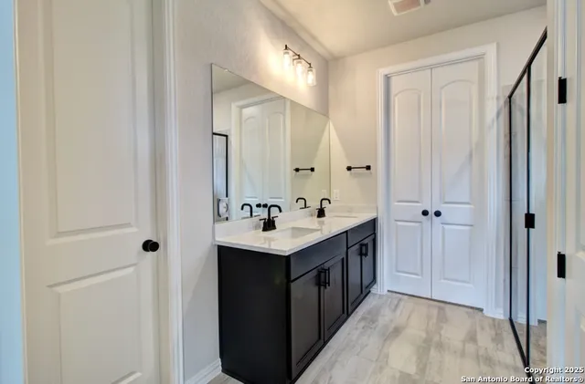 a bathroom with a sink double vanity and a mirror