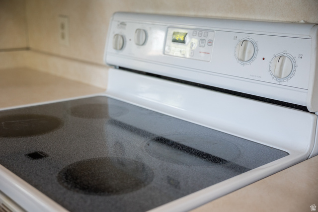 634 South 2100th Street West Vernal, UT 84078 - Photo 17 of 71 White electric range with a black ceramic glass cooktop and dial controls