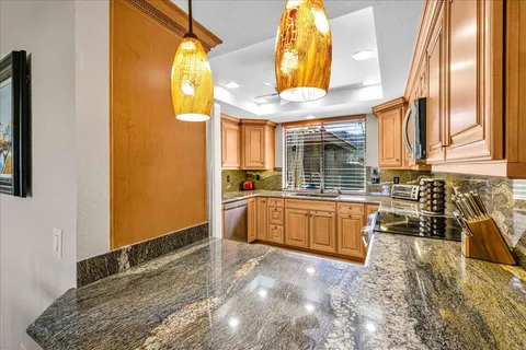 a spacious bedroom with a bed and a chandelier