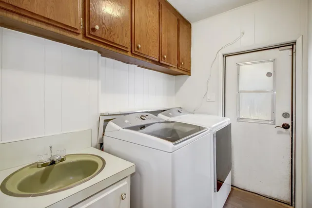 a utility room with a sink washer and dryer
