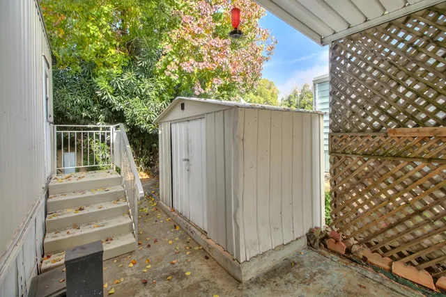 a view of small house with wooden fence