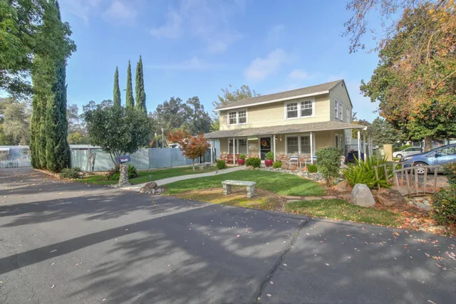 a view of pool with a yard and plants