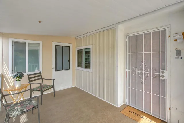 a view of a livingroom with wooden floor and a chair