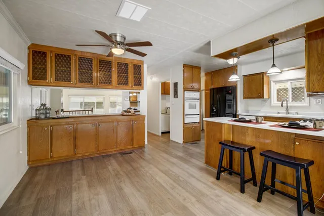 a kitchen with stainless steel appliances granite countertop a stove and cabinets