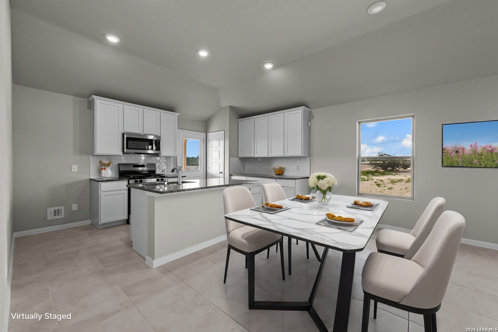 4810 Rio Ruidoso Von Ormy, TX 78073 - Photo 5 of 31 a kitchen with a dining table chairs and microwave