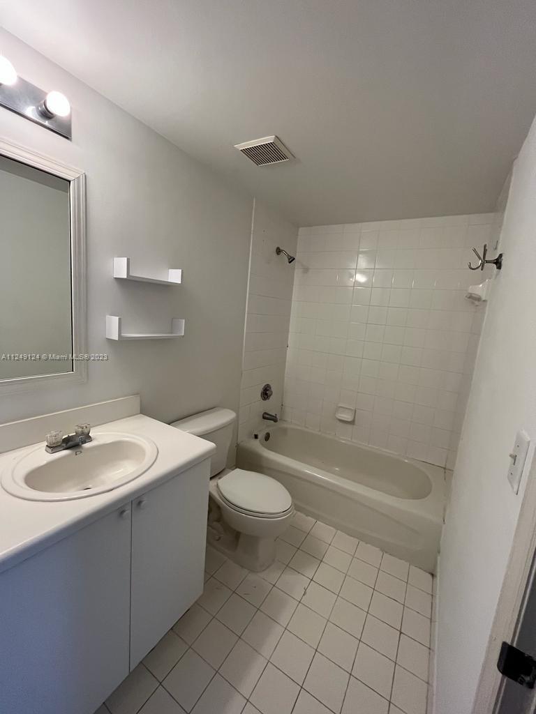 Central Gables Coral Gables, FL 33134 - Photo 11 of 14 a bathroom with a sink a toilet and shower