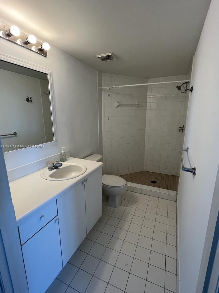 Central Gables Coral Gables, FL 33134 - Photo 13 of 14 a bathroom with a sink a toilet and shower