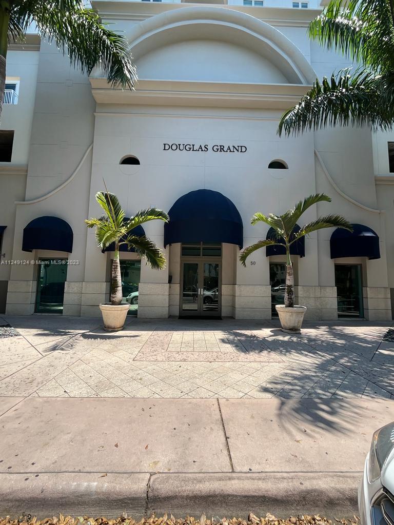 Central Gables Coral Gables, FL 33134 - Photo 2 of 14 a front view of a house with potted plants