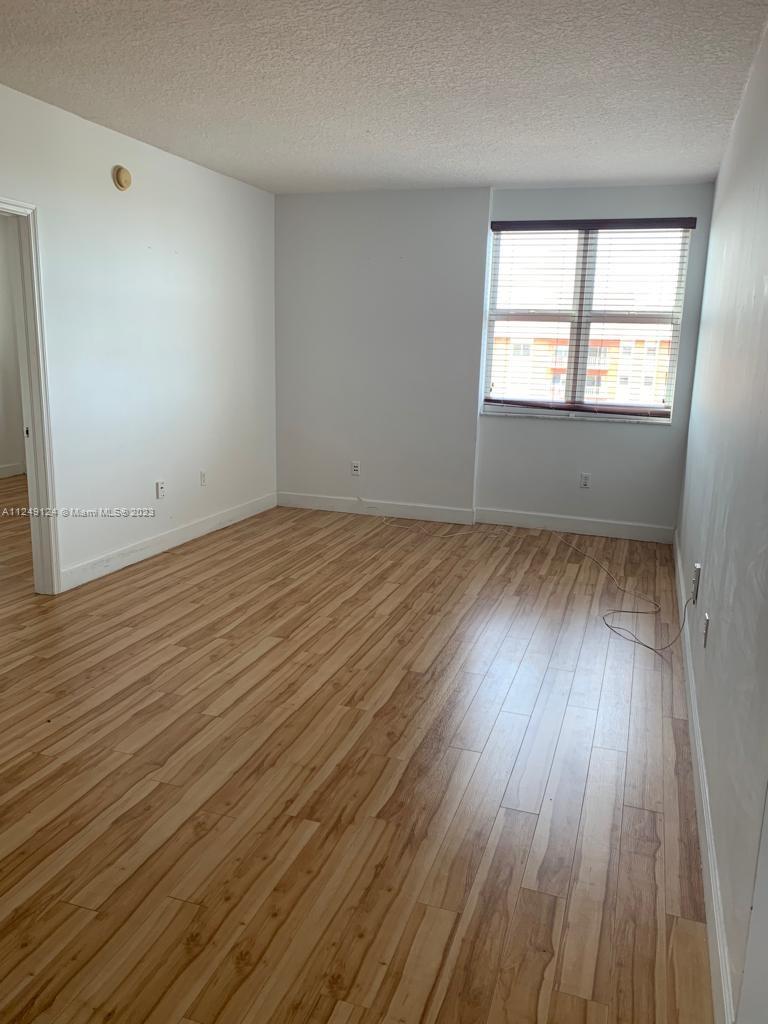 Central Gables Coral Gables, FL 33134 - Photo 7 of 14 an empty room with wooden floor and windows