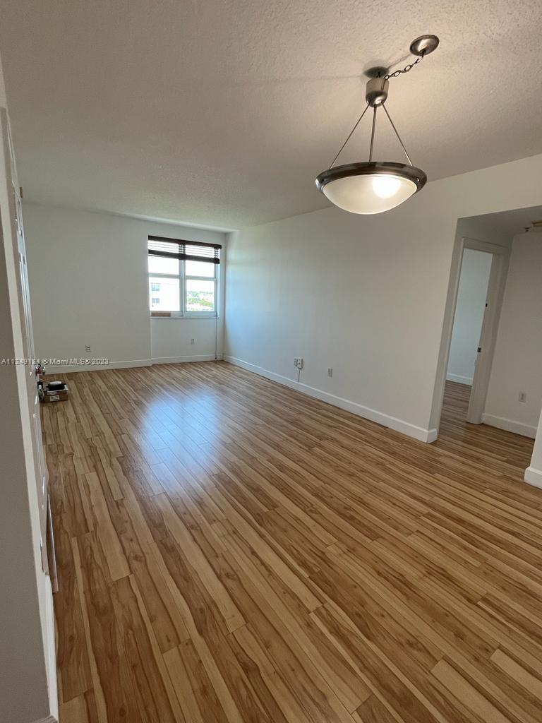 Central Gables Coral Gables, FL 33134 - Photo 8 of 14 a view of empty room with wooden floor and window