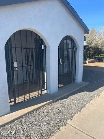 a view of a house with wooden floor and wooden fence
