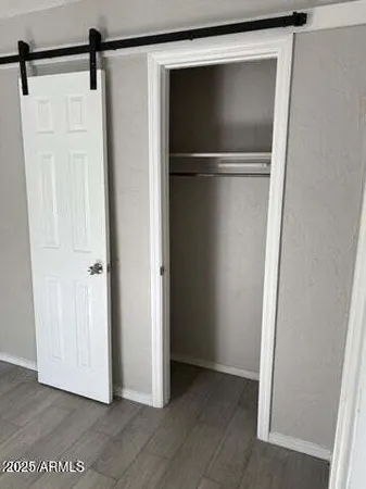 a view of walk in closet with empty racks