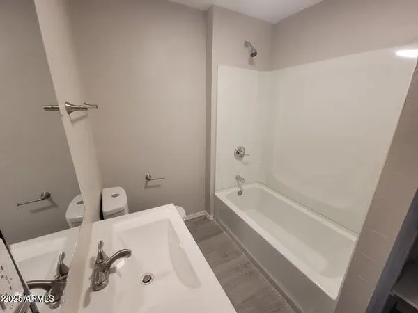 a bathroom with a bathtub sink and toilet