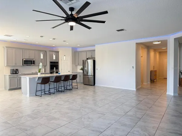 a view of kitchen with furniture and refrigerator