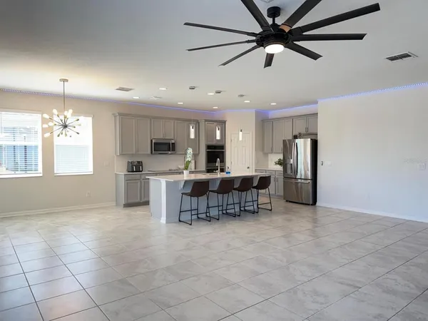 a view of a kitchen with furniture and a ceiling fan