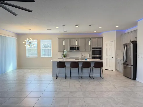 a kitchen with stainless steel appliances a refrigerator sink and cabinets