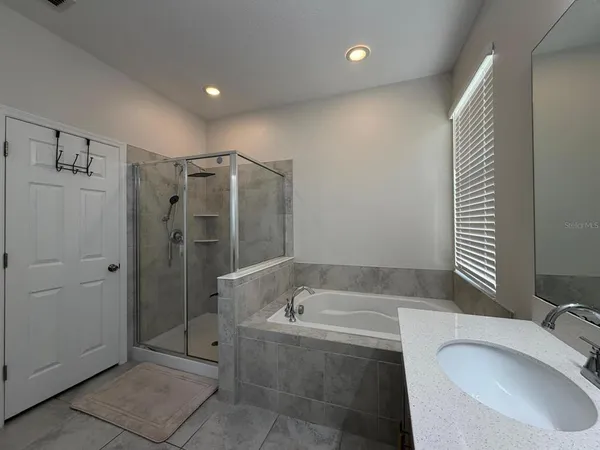 a bathroom with a granite countertop sink and mirror