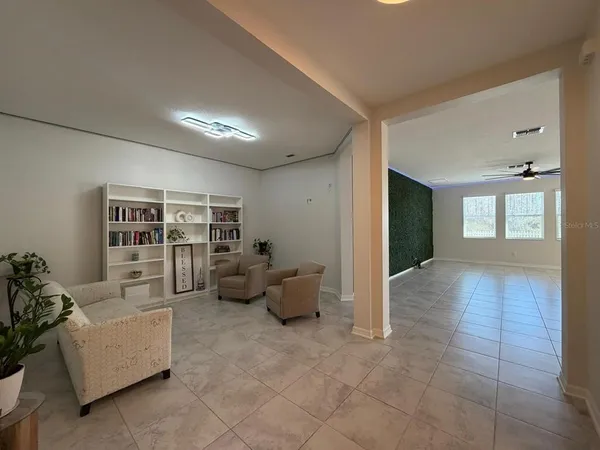a living room with furniture and view of kitchen