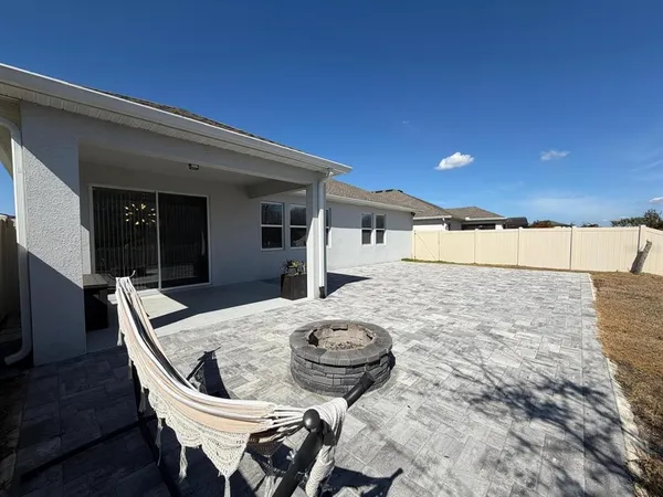 a outdoor space with a table and chairs