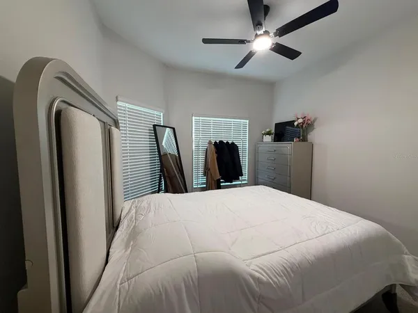 a bedroom with a bed and a chandelier