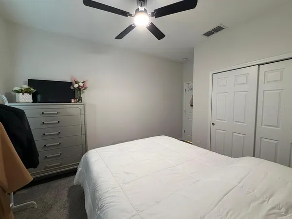 a bedroom with a bed and a chandelier