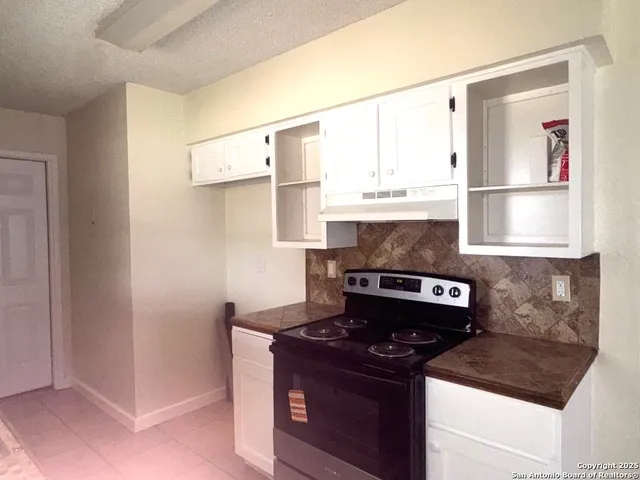 a kitchen with stainless steel appliances granite countertop a stove and a refrigerator