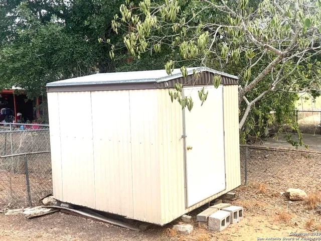 a view of a garage with a tree