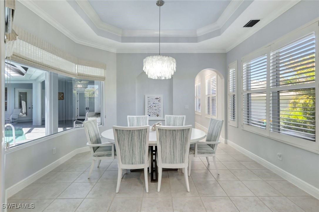 2450 Wulfert Road Sanibel, FL 33957 - Photo 24 of 44 a view of a dining room with furniture and window