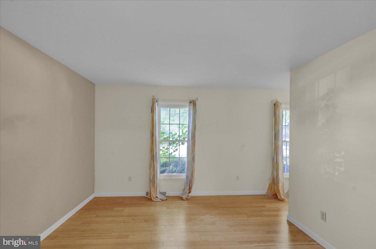 802 Apple Drive Reading, PA 19610 - Photo 11 of 47 an empty room with wooden floor and windows
