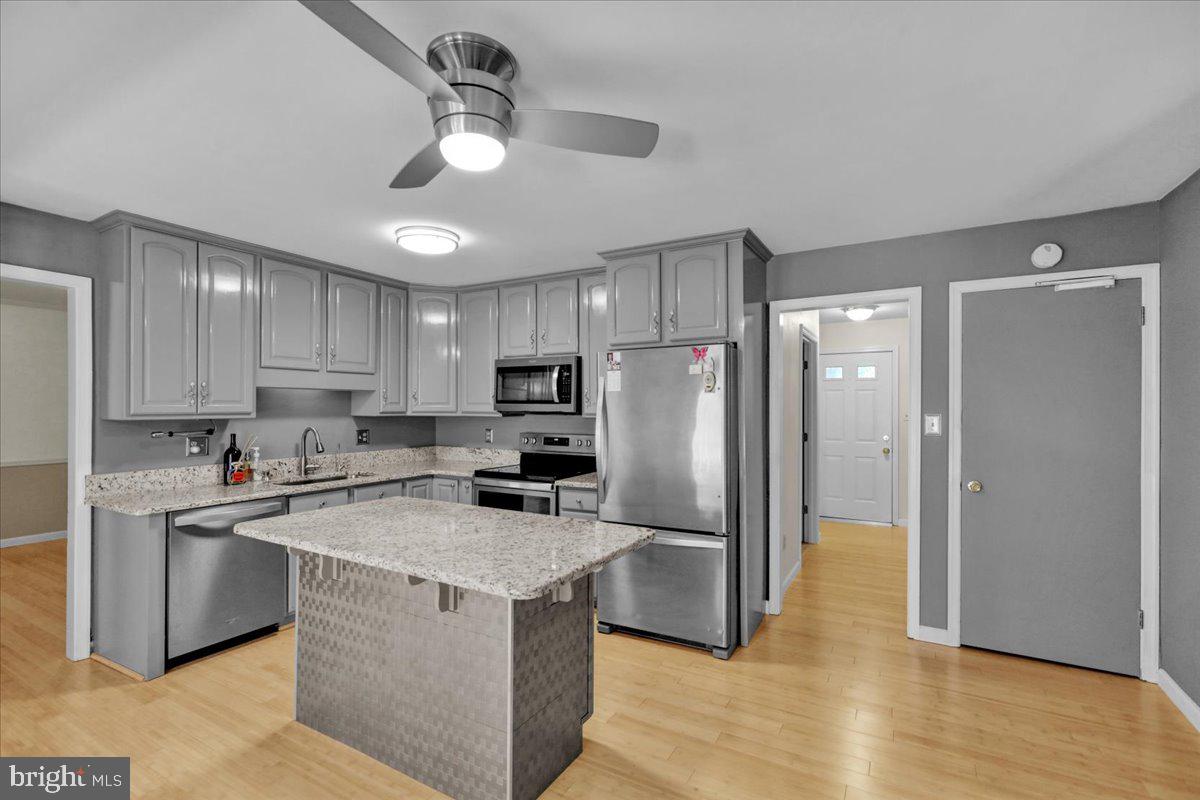 802 Apple Drive Reading, PA 19610 - Photo 21 of 47 a kitchen with a refrigerator a sink a stove a microwave and cabinets